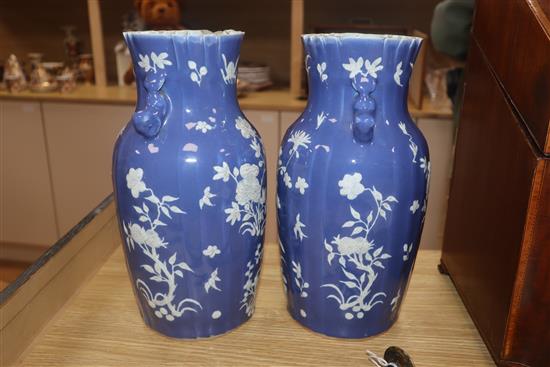 A pair of 19th century Chinese blue ground vases, with white floral decoration